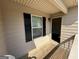 Covered porch area features a window with black shutters and access to the front door at 1853 Broad River Rd, Atlanta, GA 30349