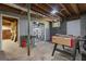 Unfinished basement featuring a foosball table, painted gray walls, and exposed ceilings at 23 Hunting Creek Dr, Marietta, GA 30068