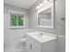 Bright bathroom with white vanity, a stylish mirror, and a sunlit window with a pleasant view at 23 Hunting Creek Dr, Marietta, GA 30068