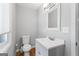Cozy bathroom featuring a white vanity, toilet, and window, complemented by hardwood flooring at 23 Hunting Creek Dr, Marietta, GA 30068
