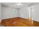 A minimalist bedroom featuring hardwood floors, neutral walls, and a ceiling fan at 23 Hunting Creek Dr, Marietta, GA 30068