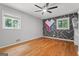 Bedroom features hardwood floors, a ceiling fan, and two windows that provide ample natural light at 23 Hunting Creek Dr, Marietta, GA 30068