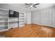 Spacious bedroom featuring hardwood floors, a ceiling fan, built-in shelving, and dual closets at 23 Hunting Creek Dr, Marietta, GA 30068