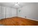 A bright bedroom features hardwood floors, ample closet space, and a ceiling fan at 23 Hunting Creek Dr, Marietta, GA 30068
