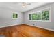 A sunlit bedroom boasts hardwood floors, two large windows, and neutral walls at 23 Hunting Creek Dr, Marietta, GA 30068