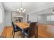 Dining area with hardwood floors, modern chandelier, fireplace, and dining table with chairs at 23 Hunting Creek Dr, Marietta, GA 30068