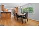 Dining area featuring wood floors, large window, and table with chairs, adjacent to the kitchen at 23 Hunting Creek Dr, Marietta, GA 30068