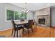 Dining area with a large window, stone fireplace and a table with chairs at 23 Hunting Creek Dr, Marietta, GA 30068