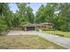 Charming brick home with an attached garage, a spacious front lawn, and a large driveway perfect for parking at 23 Hunting Creek Dr, Marietta, GA 30068