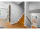 Bright entryway features hardwood floors, wooden stairs, and a view into a living room with a stone fireplace at 23 Hunting Creek Dr, Marietta, GA 30068