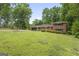 Exterior elevation of a brick home with a well-manicured lawn and a long driveway at 23 Hunting Creek Dr, Marietta, GA 30068