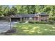 Charming single Gathering home with manicured front lawn and brick facade, nestled in a lush, green neighborhood at 23 Hunting Creek Dr, Marietta, GA 30068
