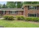 Charming brick home with a red front door and manicured landscaping, providing excellent curb appeal at 23 Hunting Creek Dr, Marietta, GA 30068