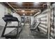 Basement home gym with a treadmill, weight rack, and mirrored wall on a black rubber floor at 23 Hunting Creek Dr, Marietta, GA 30068