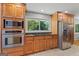 A well-equipped kitchen featuring wood cabinets, stainless steel appliances, and a view of the backyard at 23 Hunting Creek Dr, Marietta, GA 30068