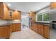 A spacious kitchen with wood cabinetry, stainless steel appliances, granite countertops, and exterior access at 23 Hunting Creek Dr, Marietta, GA 30068