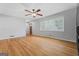 Bright living room with hardwood floors, large window with blinds, and ceiling fan at 23 Hunting Creek Dr, Marietta, GA 30068