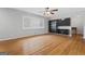 Bright living room featuring hardwood floors, a ceiling fan, a large window, and built-in shelving with a tv at 23 Hunting Creek Dr, Marietta, GA 30068