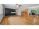 Open-concept living room featuring hardwood floors, built-in shelving, ceiling fan, and easy access to dining and kitchen at 23 Hunting Creek Dr, Marietta, GA 30068