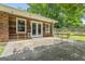 Back patio features an outdoor dining set, wood siding, and a fenced yard at 23 Hunting Creek Dr, Marietta, GA 30068