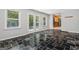 Sun room filled with light showcasing tiled floors and a door leading to the backyard at 23 Hunting Creek Dr, Marietta, GA 30068