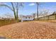 Expansive backyard with a wooden fence, mature trees, and a view of the home's rear exterior at 1318 Beecher Sw St, Atlanta, GA 30310