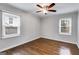 Bright bedroom with hardwood floors, two windows letting in plenty of natural light, and neutral walls at 1318 Beecher Sw St, Atlanta, GA 30310