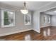 Dining room with hardwood floors and natural light, showcasing open floor plan to living area at 1318 Beecher Sw St, Atlanta, GA 30310