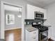 Updated kitchen with stainless steel appliances, gray subway tile backsplash, and white cabinetry at 1318 Beecher Sw St, Atlanta, GA 30310