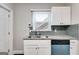 Galley kitchen featuring granite countertops, stainless steel sink, and white cabinets at 1318 Beecher Sw St, Atlanta, GA 30310