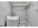 Functional laundry room with modern washer and dryer, accompanied by wire shelving for easy organization at 1318 Beecher Sw St, Atlanta, GA 30310