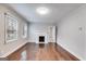 Spacious living room with hardwood floors, neutral walls, a decorative fireplace and two windows at 1318 Beecher Sw St, Atlanta, GA 30310