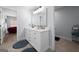 Bright bathroom featuring a double vanity, large mirror, and stylish rugs complementing the tile flooring at 68 Edwin Pl, Atlanta, GA 30318