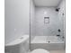 Modern bathroom features a tub/shower with glass screen and a tiled alcove, complemented by sleek fixtures at 68 Edwin Pl, Atlanta, GA 30318