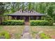 Charming home featuring a cozy front porch, dormer windows, and a well-maintained lawn at 68 Edwin Pl, Atlanta, GA 30318