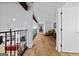 Bright hallway showcasing hardwood floors, beamed ceilings, and an open railing overlooking a living area at 68 Edwin Pl, Atlanta, GA 30318