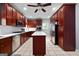 Modern kitchen featuring cherry cabinets, stainless steel appliances, and a central island with a white countertop at 68 Edwin Pl, Atlanta, GA 30318