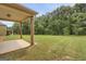 Exterior of house with a large flat concrete patio looking out to an expansive backyard at 340 Mcgiboney Ln, Covington, GA 30016