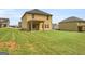 View of the house exterior and green lawn in the backyard at 340 Mcgiboney Ln, Covington, GA 30016