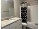 Bathroom featuring granite countertops, white cabinetry, and shower with patterned curtain at 340 Mcgiboney Ln, Covington, GA 30016