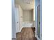 A soaking tub is situated between the glass enclosed shower and door to the water closet at 340 Mcgiboney Ln, Covington, GA 30016