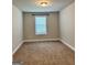 Bedroom with neutral walls, carpet flooring, and a single window for natural light at 340 Mcgiboney Ln, Covington, GA 30016