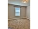 Bedroom with neutral walls, carpet flooring, and a single window for natural light at 340 Mcgiboney Ln, Covington, GA 30016
