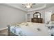 Bright bedroom featuring tray ceiling and a wooden dresser with decorative mirror at 340 Mcgiboney Ln, Covington, GA 30016