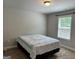 Bedroom with neutral walls, carpet flooring, and a window with a bed at 340 Mcgiboney Ln, Covington, GA 30016