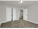 Bedroom featuring carpeted floors, light gray walls, an open closet and overhead lighting at 340 Mcgiboney Ln, Covington, GA 30016