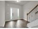 View of the foyer featuring hard surface floors, staircase, and neutral paint at 340 Mcgiboney Ln, Covington, GA 30016