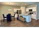 Kitchen and dining area with stainless steel appliances, granite island, and wooden floors at 340 Mcgiboney Ln, Covington, GA 30016