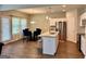 Well-lit kitchen and dining area with stainless steel appliances, island, and wooden floors at 340 Mcgiboney Ln, Covington, GA 30016