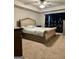 The main bedroom features a plush headboard, tray ceilings, and natural light from a large window at 340 Mcgiboney Ln, Covington, GA 30016